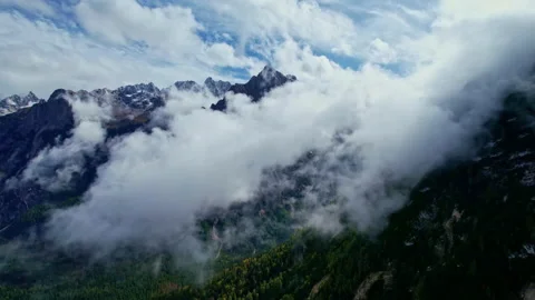 Aerial view of the Dolomites through the clouds Stock Footage 220663754