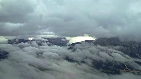 Aerial view of the Dolomites through the clouds Stock Footage 220665884