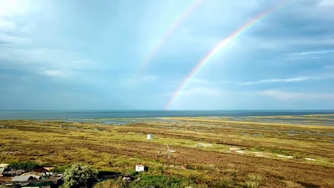 Aerial view of double rainbow over the sea Stock Footage 121517250