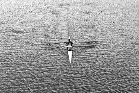 Aerial view of double scull rowing team on rippling water in black and white Photos