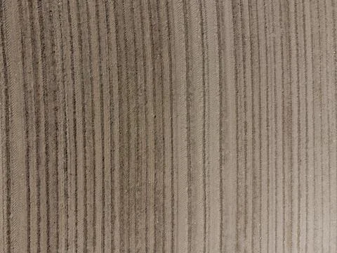Aerial view down on empty barren field with very dry soil and plough furrows  Stock Photos
