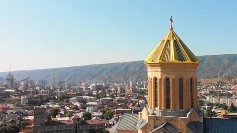 Aerial view down to Holy trinity cathedral Sameba architecture in Tbilisi. Ch Stock Footage 195240029