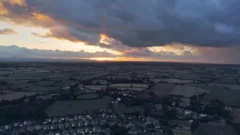 Aerial view, down move. Dramatic sky and sunset over residential buildings of Video stock 95564140