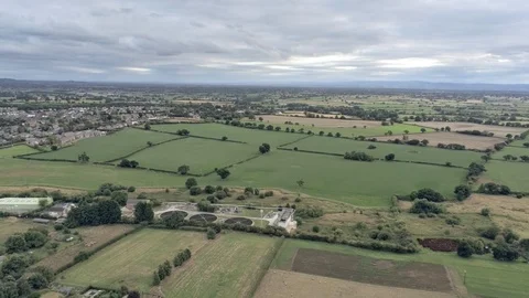 Aerial view, down move. Sewage treatment plant, houses among fields on Cheshi Stock Footage 95565825