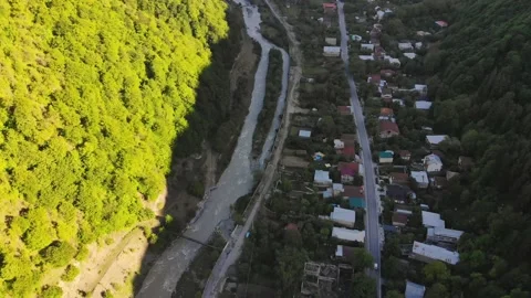 Aerial view down to river and traditional georgian houses in Pasanauri villag Stock Footage 146741901
