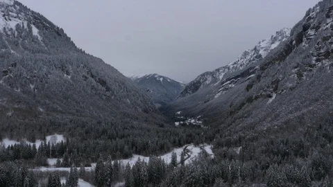 Aerial view down valley in winter. Snow covered mountains Stock Footage 102529502