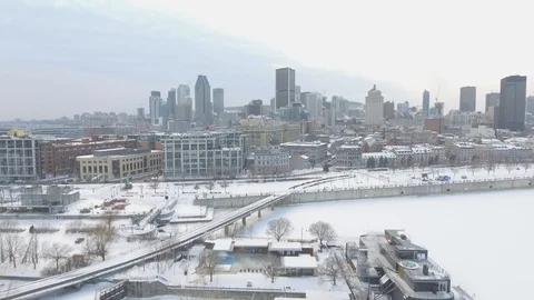 Aerial view of downtown Montreal, Quebec and the frozen St. Lawrence River Stock Footage