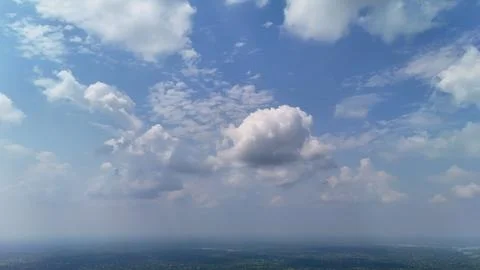 Aerial view of dramatic blue sky with fluffy white clouds Stock Photos