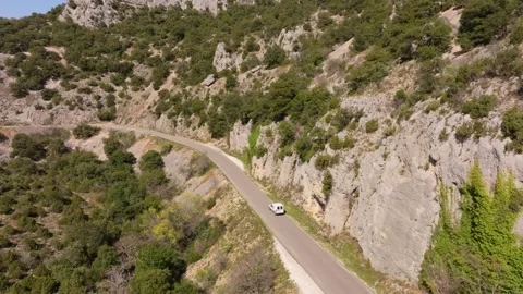 Aerial view of dramatic canyon road with light traffic near Venasque, France Stock Footage 313149411
