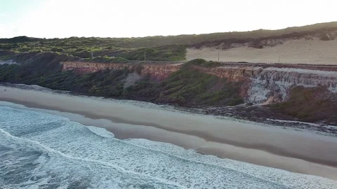 Aerial view of the dramatic cliffs and beach at Praia de Pipa, Brazil. Stock Footage 314401833