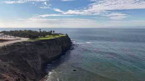 Aerial view of dramatic cliffs and serene ocean along the Pacific coast of Stock Footage 319006045