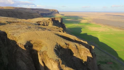 Aerial view of dramatic cliffs and green fields in Iceland. Stock Footage 340605881
