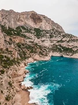 Aerial view of dramatic cliffs and turbulent waves along rugged coastline Stock Photos