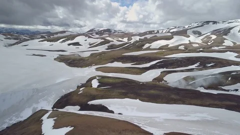 Aerial view of dramatic clouds over snowy volcanic mountains in Iceland Stock-Footage 89024783