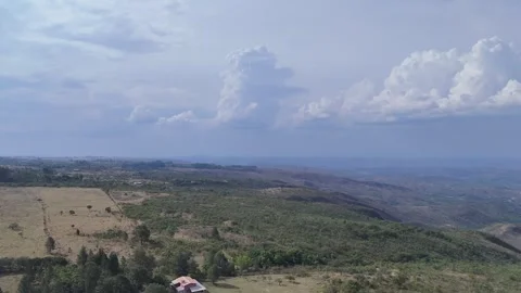 Aerial View of Dramatic Clouds Over Rolling Countryside 動画素材 325593545