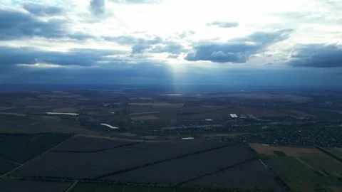 Aerial view of dramatic cloudy sky and farmland with sun rays 스톡 동영상 319815601