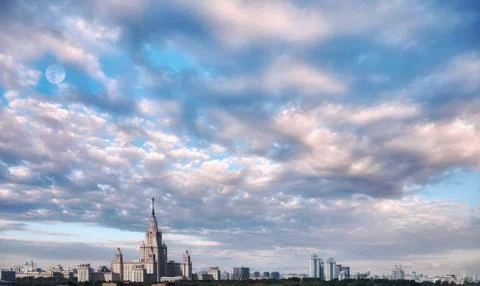 Aerial view of dramatic cloudy sky over main building of old university in su Stock Photos