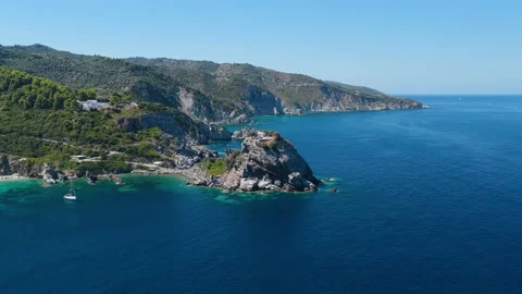 Aerial view of the dramatic coastal cliffs and turquoise waters surrounding the Stock Footage 346720063