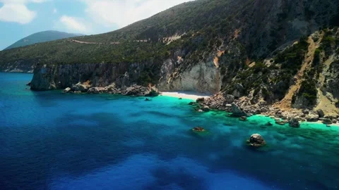 Aerial view of dramatic coastal cliffs, white sand, and turquoise water at Stock Footage 346789168