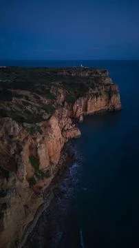Aerial View of Dramatic Coastal Cliffs and Ocean at Dusk Stock Photos