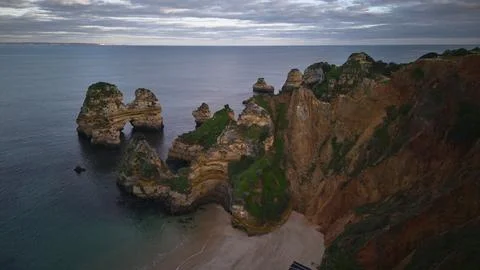 Aerial View of Dramatic Coastal Cliffs and Beach at sunset. Lagos, Algarve,.. Stock Photos