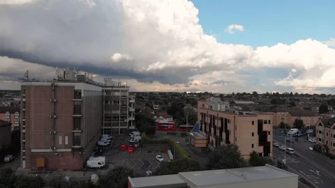 Aerial view of dramatic dark thunder storm clouds rolling over city of Stock Footage 93691496