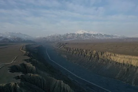 Aerial View of Dramatic Eroded Canyon with Highway Through Western China Dese Stock Photos
