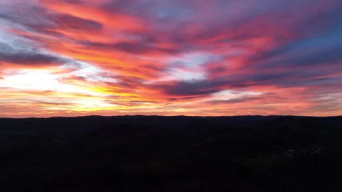 Aerial view of dramatic fiery orange and red sunset over the hills of Correze Stock Footage 337967346