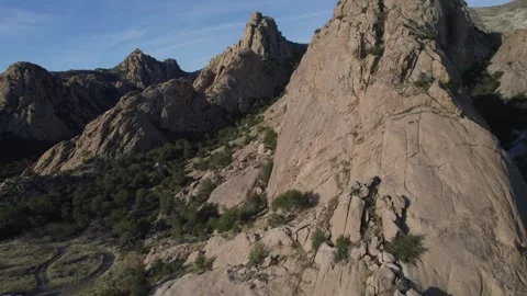 Aerial view of dramatic granite spires in a desert mountain range Stock Footage 329768830