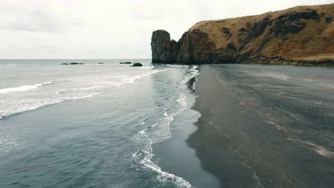 Aerial View of Dramatic Ocean Waves Break on a Wild Beach with Cloudy Horizon 4k Stock Footage 150153790