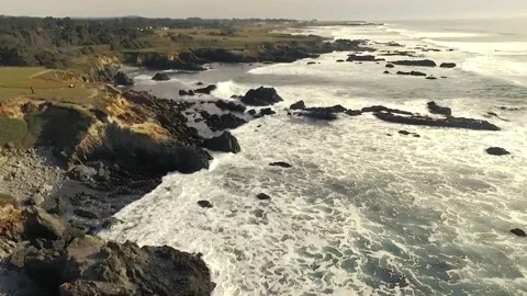 Aerial View of Dramatic Pacific Coastline with Waves Crashing on Rocky Shore Stock Footage 302306954