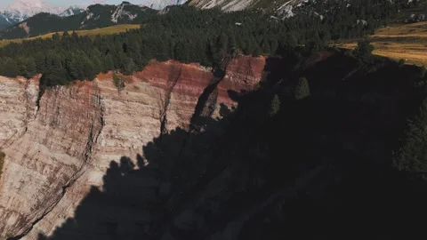 Aerial view of dramatic red rock cliffs and forest in the Dolomites, Italy. Stock Footage 316804754