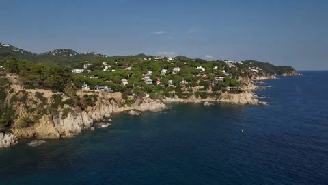 Aerial view of dramatic rocky coastline from open sea Stock Footage 321346057