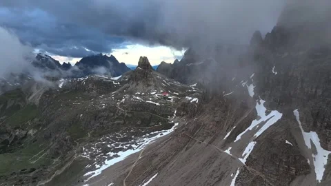 Aerial view of dramatic rocky mountain peaks with clouds and snow . Stockbeeldmateriaal 342705732