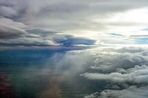 Aerial view dramatic storm clouds over land, heavy rain falling from dark sky Stock Photos