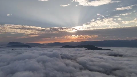 Aerial View of Dramatic Sun Rays Above Sea of Clouds at Dawn, Luang Prabang Stock-Footage 347422949