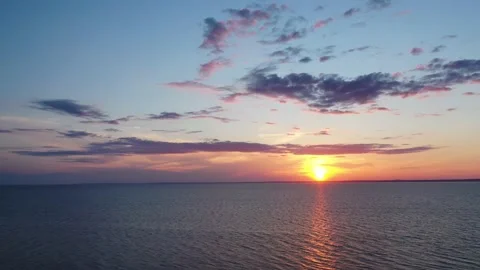 Aerial view of a dramatic sunset and the setting sun, beautiful clouds at sunset Stock Footage 171608381