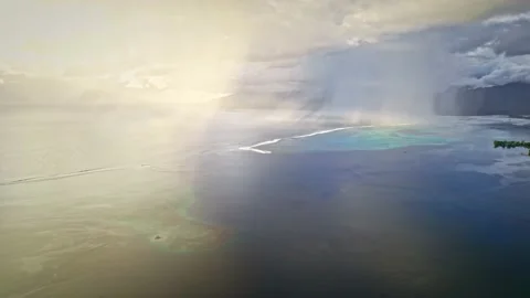 Aerial view of dramatic sunset rain, sunrays, clouds in Pacific ocean, Polynesia Stock Footage 167210951