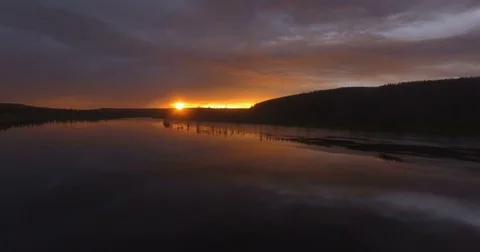 Aerial view of dramatic sunset reflecting in river Stock Footage 78706873
