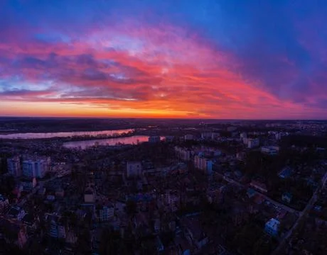 Aerial view of dramatic sunset sky above the city at dusk. Stock Photos