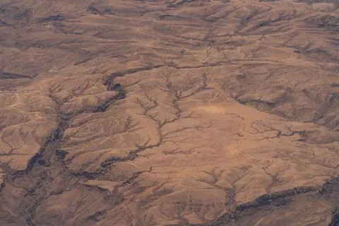 Aerial view of dramatic texture and patterns on the barren desert landscape Stock Photos
