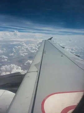 Aerial View of Dramatic White Clouds from Airplane Window with Jet Engine 2. Stockfoto's