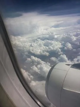 Aerial View of Dramatic White Clouds from Airplane Window with Jet Engine 3. Stock Photos