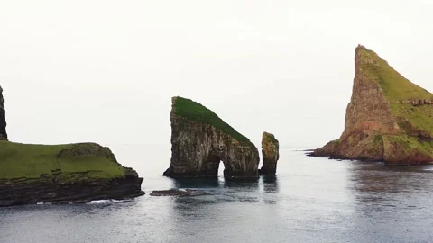 Aerial view of Drangarnir, a sea stack in the Faroe Islands. Video stock 154555042