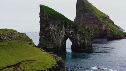 Aerial view of Drangarnir, a sea stack in the Faroe Islands. Video stock 154555193