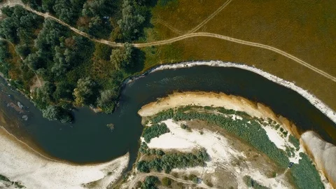 Aerial view of a dried river, field and forest in the summer Stock Footage 115239019