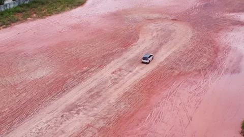 Aerial view of a driver learning to drive in an empty lot Stock Footage 325641220