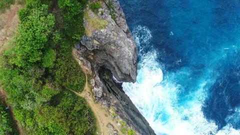 Aerial view by drone 4k camera. Ocean with waves and rocky cliff. Video stock 86168340