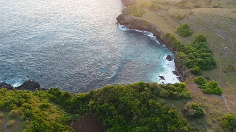 Aerial view by drone 4k camera. Ocean with waves and rocky cliff. Stock Footage 86174016