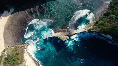 Aerial view by drone 4k camera. Rocks in a blue sea lagoon with breaking waves. Stock Footage 93706391